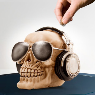 Skull-shaped piggy bank with glasses and headphones
