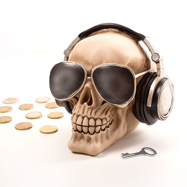 Skull-shaped piggy bank with glasses and headphones