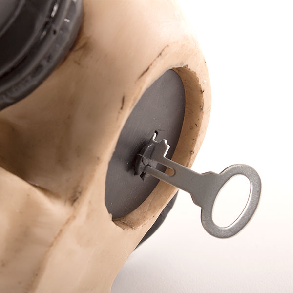 Skull-shaped piggy bank with glasses and headphones