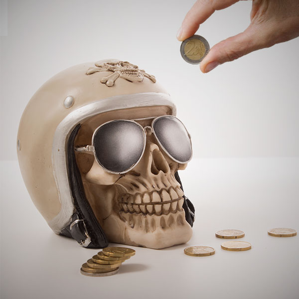 Skull-shaped piggy bank with biker helmet Skull-shaped piggy bank with biker helmet