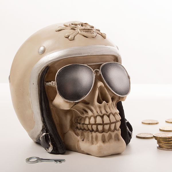 Skull-shaped piggy bank with biker helmet Skull-shaped piggy bank with biker helmet