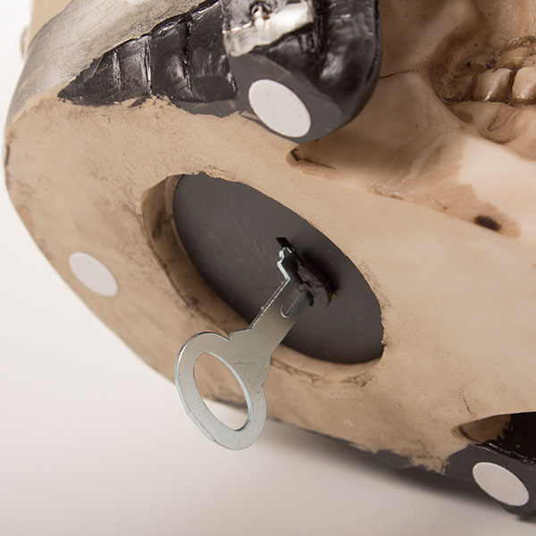 Skull-shaped piggy bank with biker helmet Skull-shaped piggy bank with biker helmet