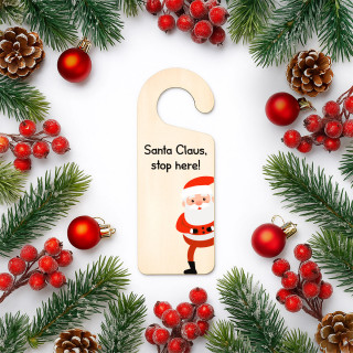 Hanging wooden sign on the door "Santa Claus, stop here" Hanging wooden sign on the door "Santa Claus, stop here"