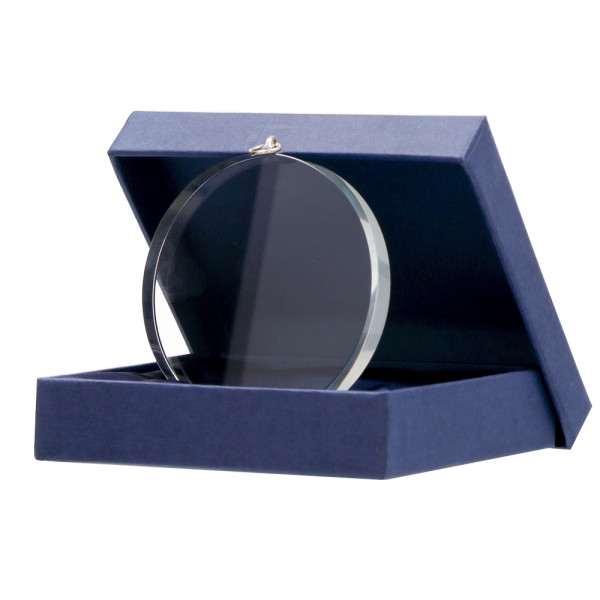 A glass medal in a box without print